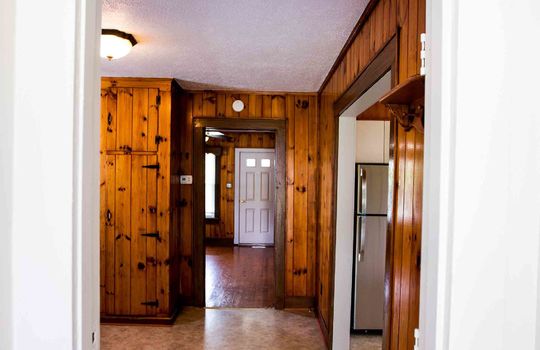 front door entry, living room, knotty pine walls, laminate flooring
