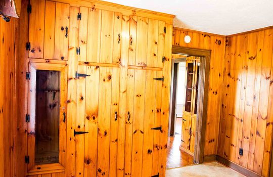 living room, knotty pine walls, laminate flooring