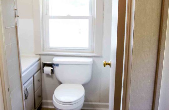 bathroom, sink, toilet, window, laminate flooring, cabinets