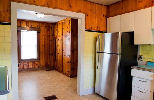 kitchen, stainless steel refrigerator, laminate flooring, doorway to dining area