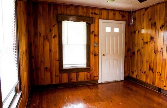 exterior door, hardwood flooring, built in window framing, ceiling fan