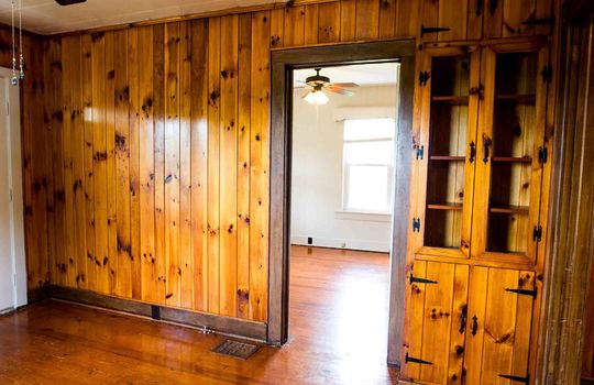dining area, hardwood flooring, built in shelving/cabinetry, knotty pine, hardwood flooring, doorwa