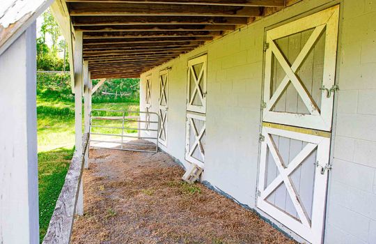 covered barn entrance, doors to barn stalls