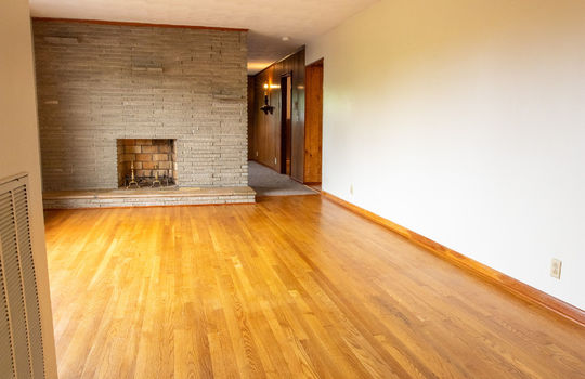 living room, hardwood flooring, fireplace, hallway