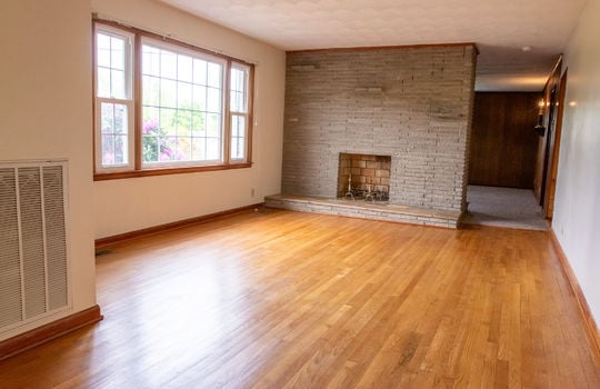 living room, hardwood flooring, fireplace, hallway, large window