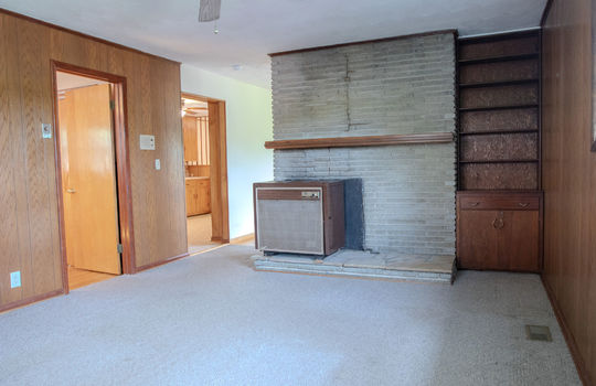 den, carpet, window, built-in shelving, window, ceiling fan