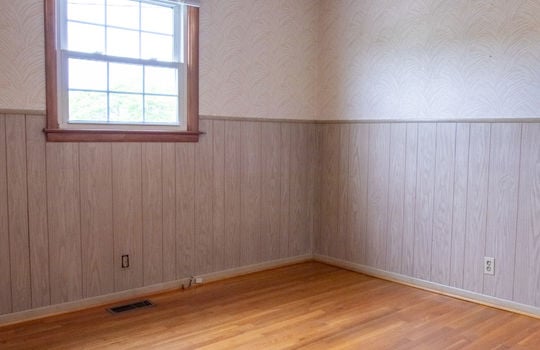 bedroom, wainscoting, hardwood flooring, window