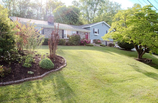 front yard, tri-level ranch, landscaping, trees, brick, vinyl siding, wood siding, front door