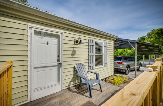 double wide, manufactured home, front porch, front door, storm door, vinyl siding, landscaping, metal roof