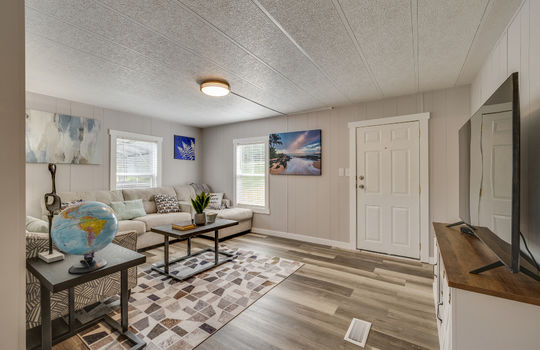 living room, laminate flooring, front door, windows