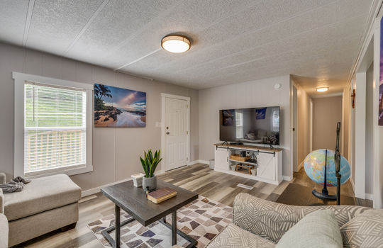 living room, hallway, laminate flooring, windows, front door