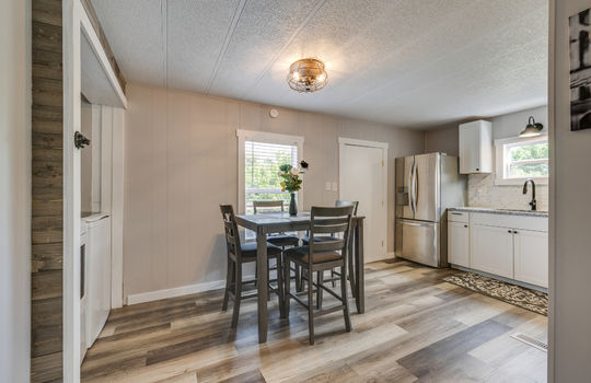 eat in kitchen, laminate flooring, refrigerator, cabinets, granite countertops, exterior door, laundry area