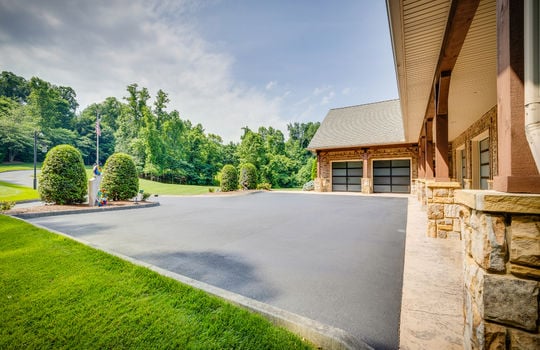 attached garage, view toward two bays, asphalt driveway, landscaping