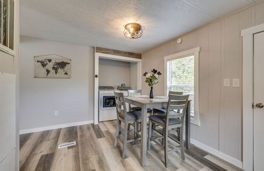 eat in kitchen, laundry area, laminate flooring, window