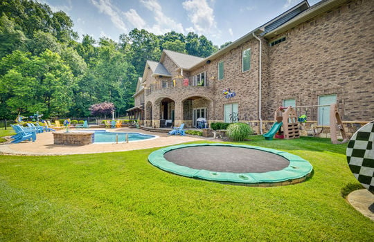 back yard, swimming pool, fencing, patio, back deck, brick home exterior, landscaping