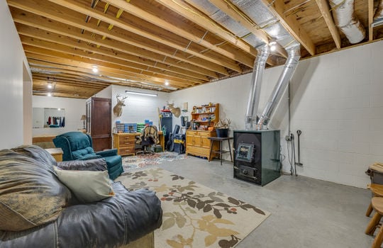 unfinished basement space, concrete flooring, beams