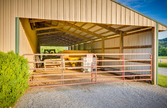 metal hay barn, gravel driveway, gates