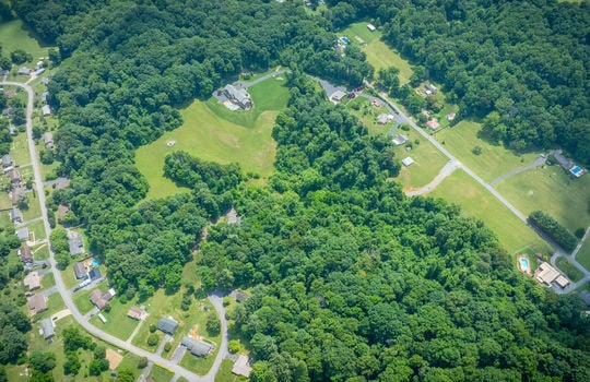 aerial view 25.72+/- acres, trees, woods, mountains, pasture, road, mountain views, neighborhood