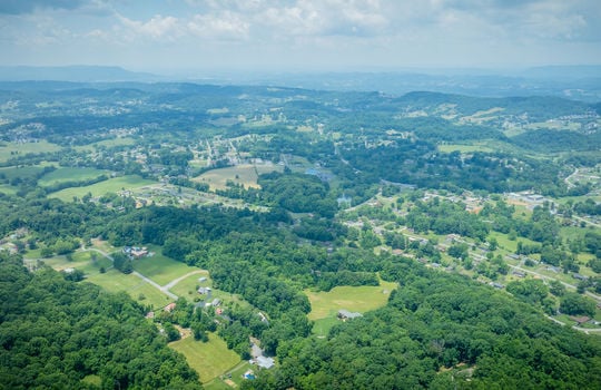 aerial view 25.72+/- acres, trees, woods, mountains, pasture, road, mountain views