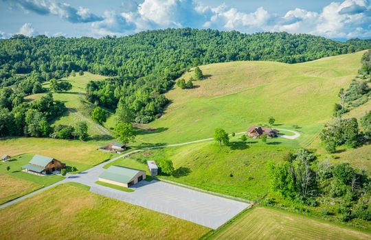 aerial view, metal hay barn, paved parking, pasture, trees, 198.92+/- acres