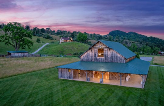 barn/event/wedding venue space, wood siding, twilight photo, yard, trees, house, mountain views