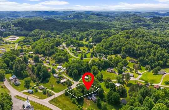 Aerial view of neighborhood, property outline, property location marker, mountains, roads