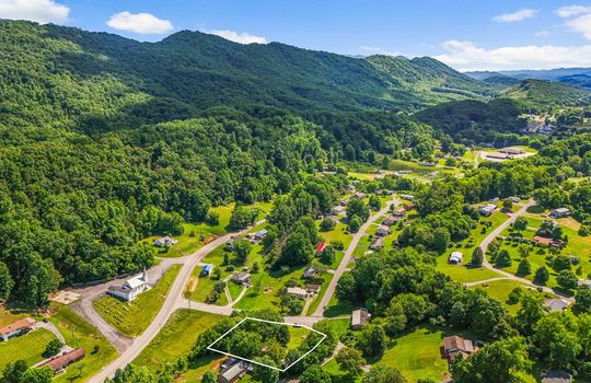 Aerial view of neighborhood, property outline, mountains, roads