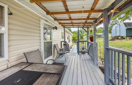 covered front porch, storm door, front door, front porch