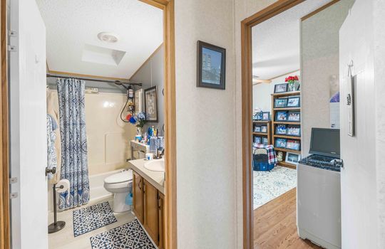 hallway view into second bathroom and third bedroom