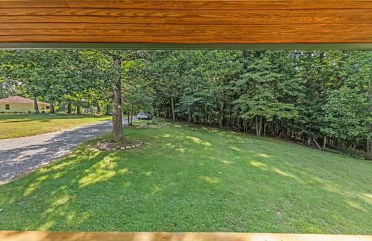 front porch, view of yard from front porch, yard, trees, gravel driveway