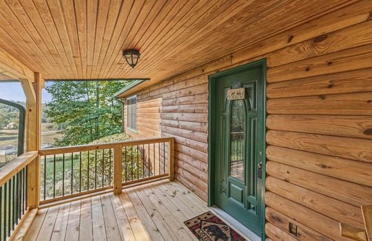 fully furnished log cabin, for lease only, front porch, front door, wood railing