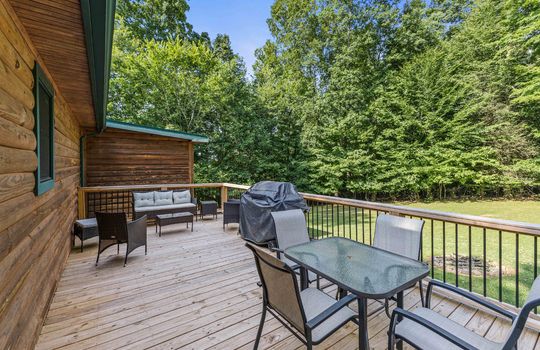 log cabin, back deck, back yard, railing, trees