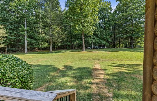 view from front porch, front yard, stair railing, trees, landscaping