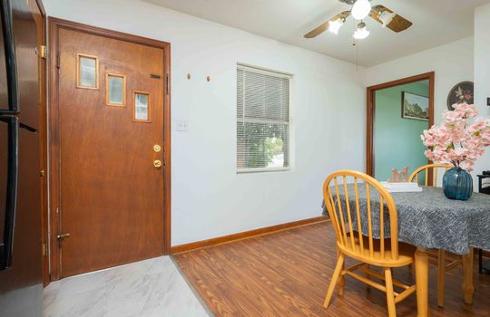 dining space, hardwood flooring, ceiling fan, exterior door, window