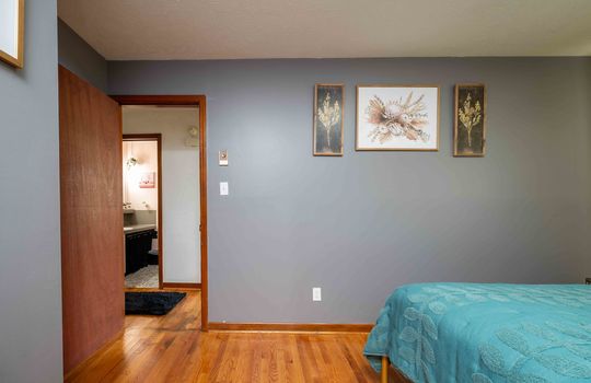 second bedroom, hardwood flooring, door to hallway