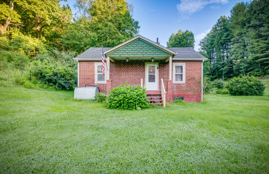 front view of home, front yard, brick, cottage, covered, front porch, front door