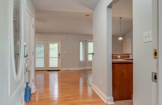 view from front door into entryway/hallway/foyer, hardwood flooring