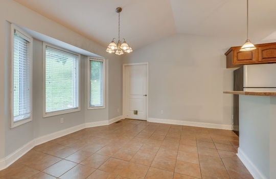 Dining area, bay window, chandelier, tile flooring