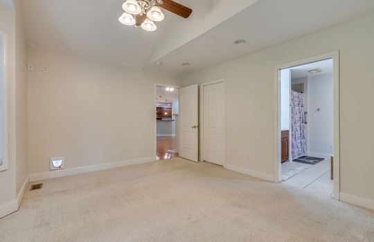 primary bedroom, carpet, ceiling fan, view into ensuite bath