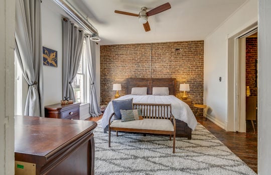 bedroom, windows, ceiling fan, exposed brick wall, hardwood flooring