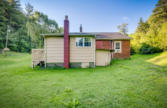 back view, cottage, brick exterior, chimney, back yard, trees