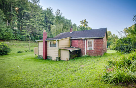 back right view of home, brick exterior, cottage, side porch, trees, back yard