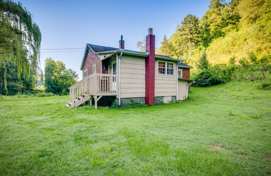 back left view of home, brick exterior, cottage, side porch, trees, back yard