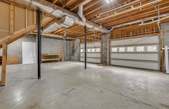 drive under garage, two garage doors, concrete flooring