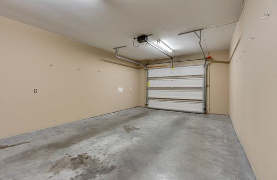 Attached garage, concrete flooring, one car garage, garage door