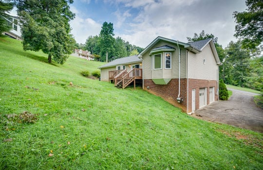 back of home, two bay garage, back yard, back deck, landscaping