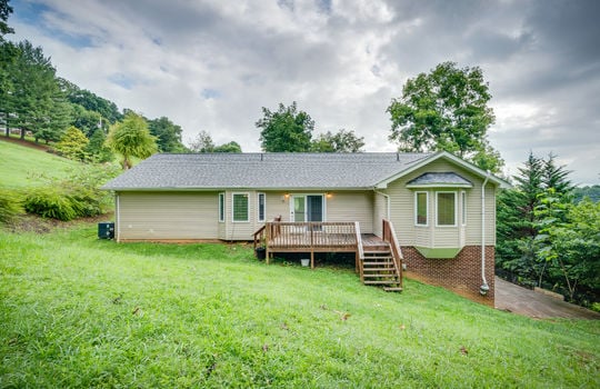 back of home, one level, vinyl siding, back deck, double door exterior entry, bay windows