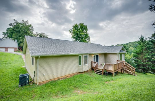 back of home, one level, vinyl siding, back deck, double door exterior entry, bay windows