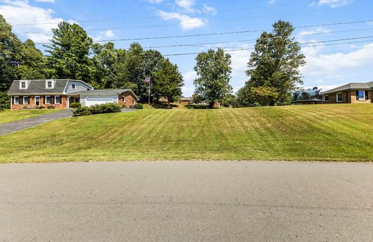 additional parcel, additional land, dutch colonial home, driveway, road, trees