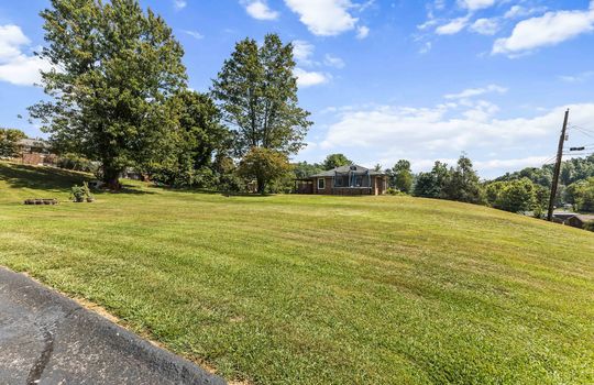 additional parcel, additional land, dutch colonial home, driveway, road, trees